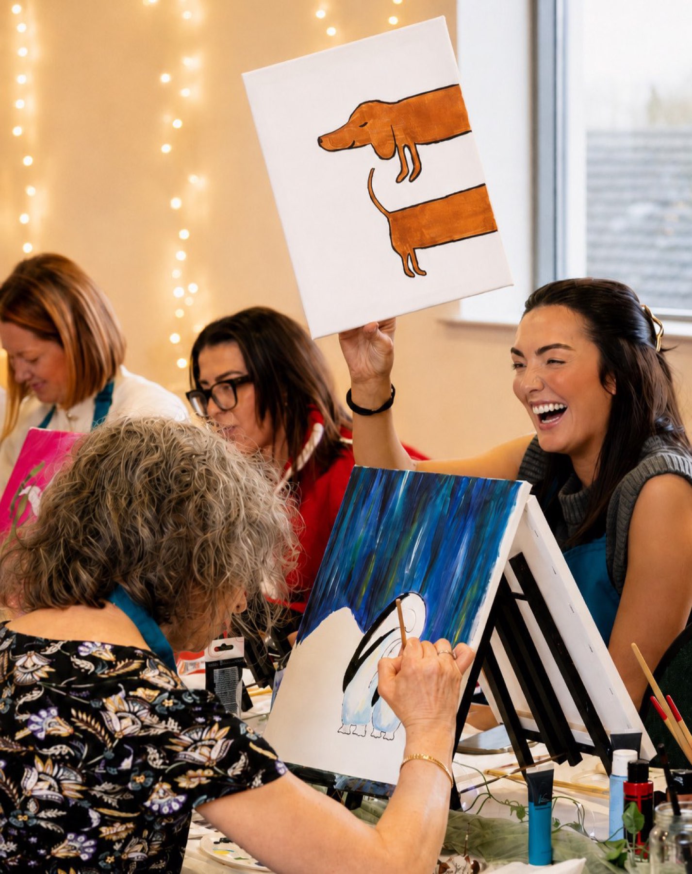 A guest laughing with her dachshund canvas