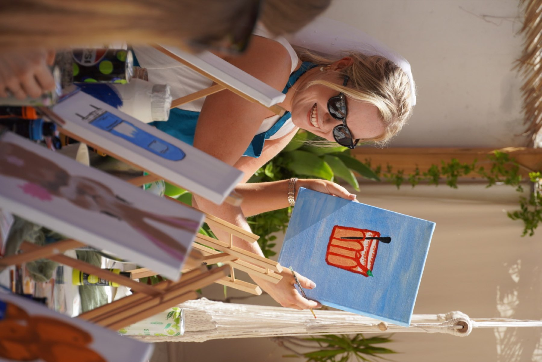 An Easel Escape artist helping a guest one-to-one with her canvas