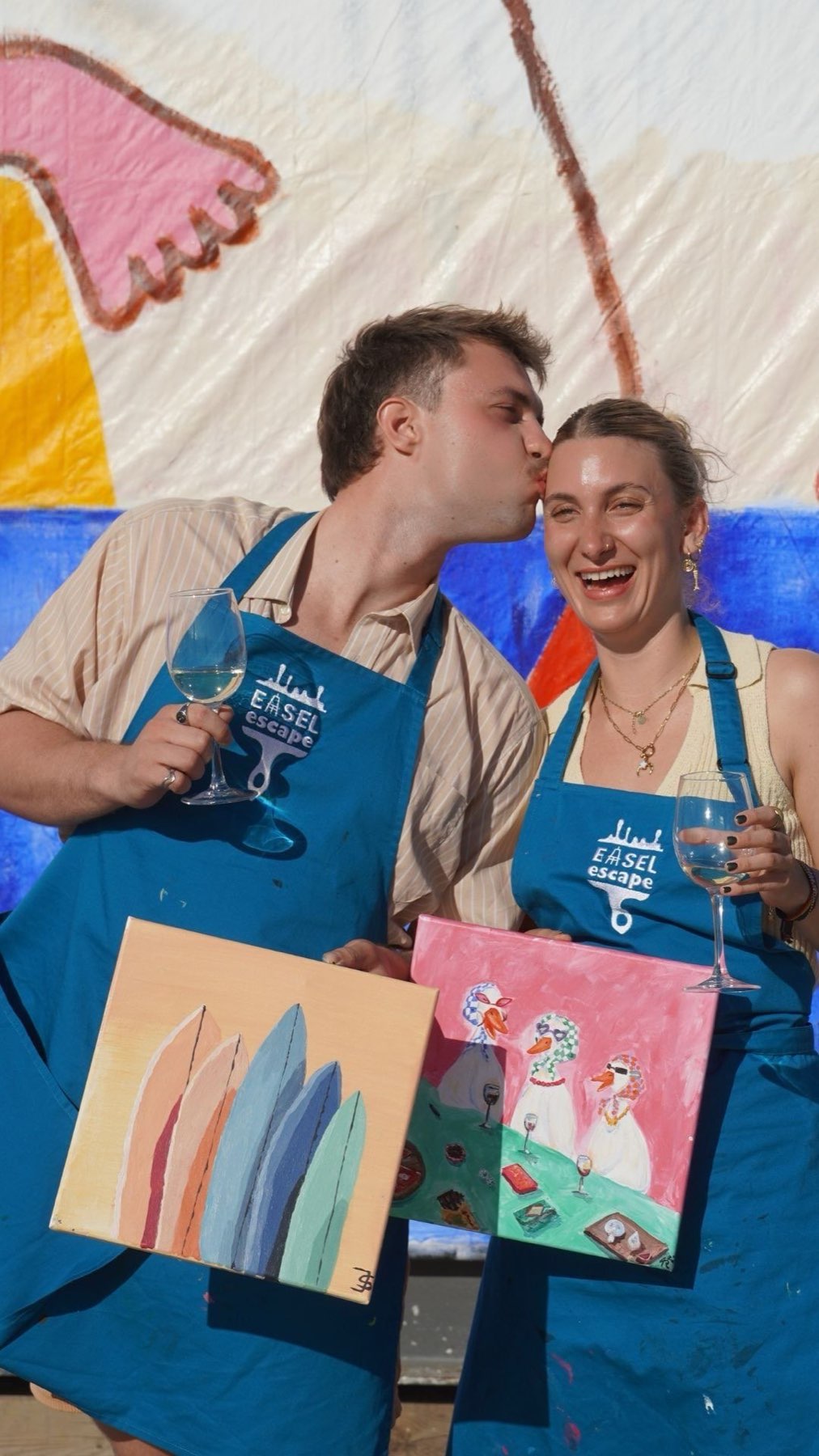 Painters mid-session, relaxed and laughing