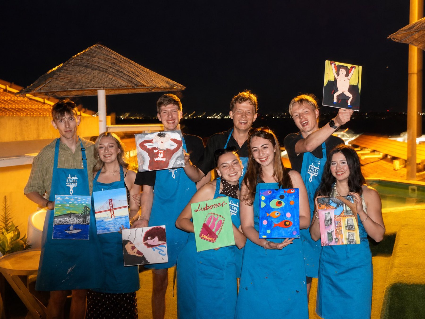 A big group with their canvases by the pool